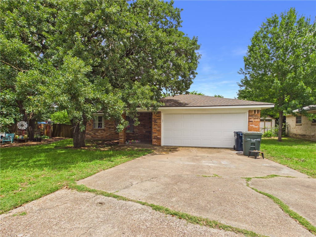 800 Rio Grande Lane Bryan, TX 77801 - Photo 2 of 23 front view of a house with a yard and an trees