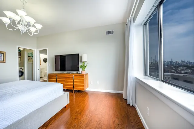 a bedroom with bed and flat screen tv
