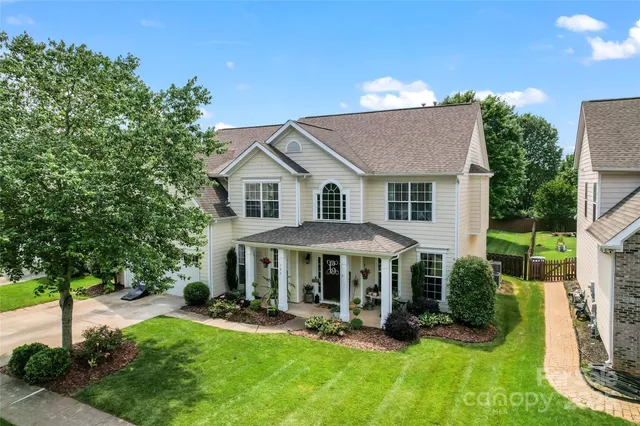 a patio with sofas fire pit table and chairs