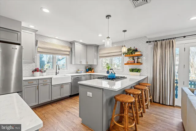 a spacious bedroom with a bed a couch and a dresser next to a window