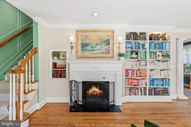 a living room with furniture and a book shelf