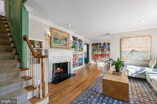 a kitchen with stainless steel appliances kitchen island granite countertop a refrigerator a sink dishwasher a stove and a dining table with wooden floor