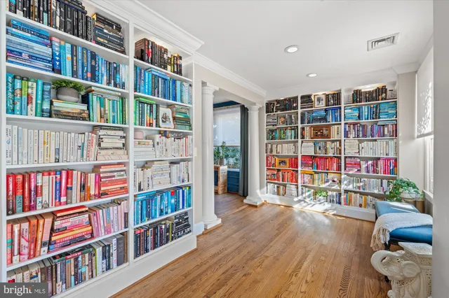 a kitchen with granite countertop a dining table chairs stainless steel appliances and cabinets