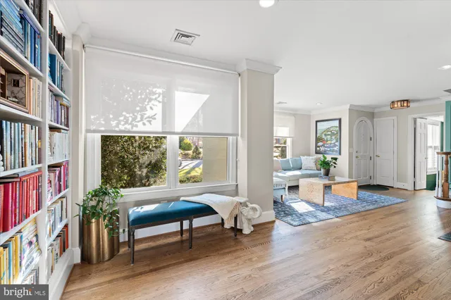 a living room with furniture and kitchen view