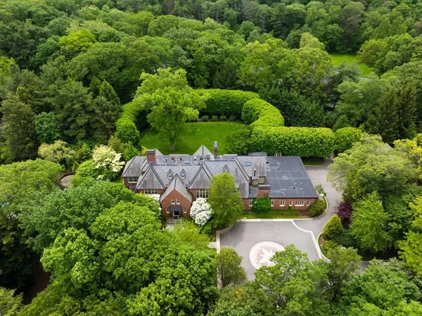 an aerial view of a house with a yard and lake view