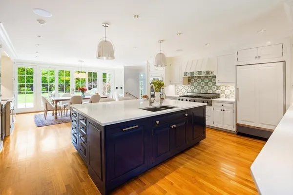 a kitchen with a sink stove and cabinets