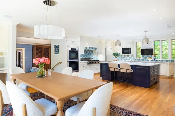a large kitchen with a table and chairs