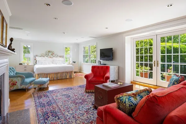 a bedroom with furniture and a large window