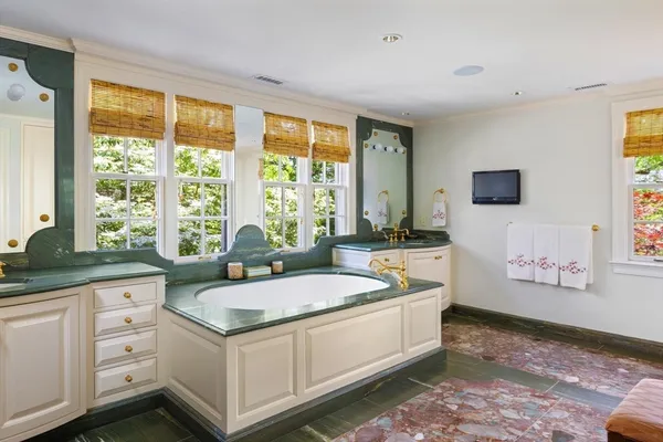 a living room with stainless steel appliances granite countertop a sink and a large window