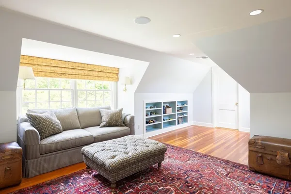 a bedroom with furniture and a window