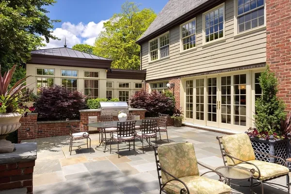 a view of a patio with table and chairs potted plants and a table and chair