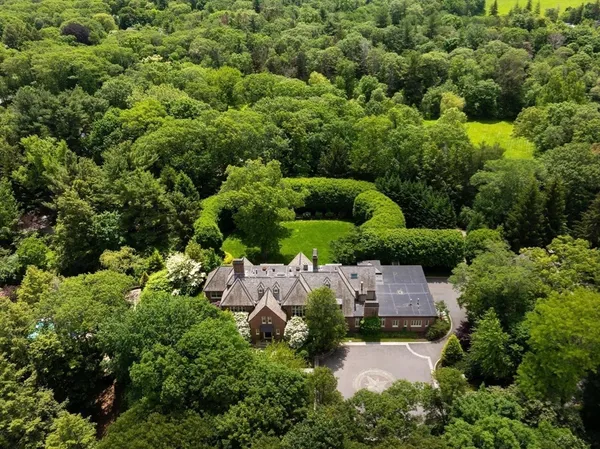 an aerial view of a house with a yard