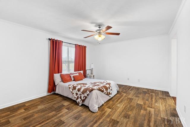 5401 Red House Road Rustburg, VA 24588 - Photo 14 of 27 a bedroom with a bed and a ceiling fan