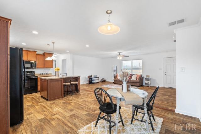 5401 Red House Road Rustburg, VA 24588 - Photo 10 of 27 a kitchen with a dining table chairs stainless steel appliances and cabinets