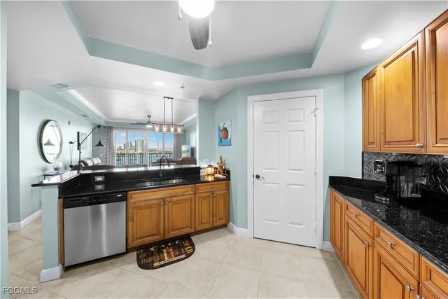a kitchen with stainless steel appliances granite countertop a sink a stove and a refrigerator