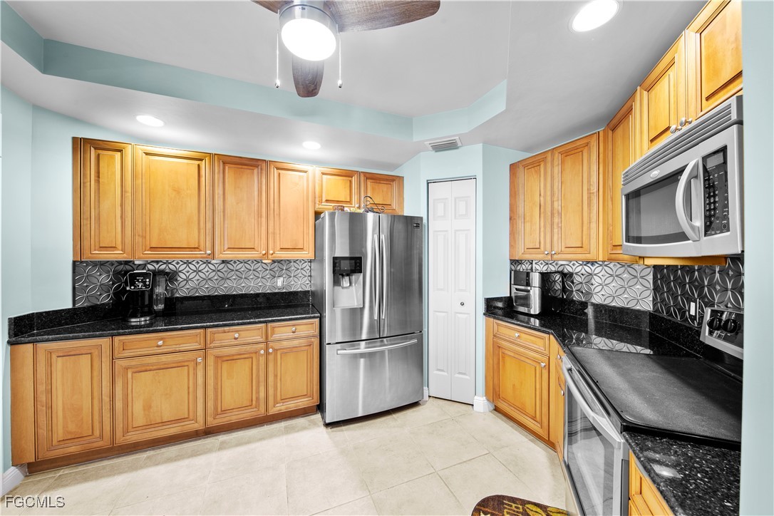 2745 First Street, Unit 801 Fort Myers, FL 33916 - Photo 13 of 50 a kitchen with granite countertop a stove a sink and a refrigerator