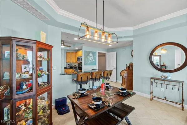 a living room with furniture a window and a chandelier