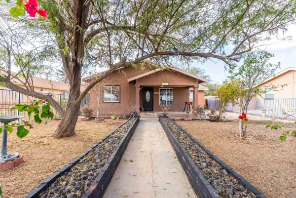 a front view of a house with garden