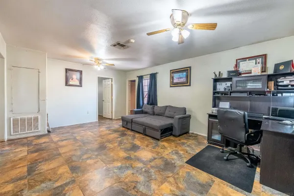 a view of a livingroom with workspace and a couch