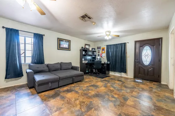 a living room with furniture a large window and a flat screen tv