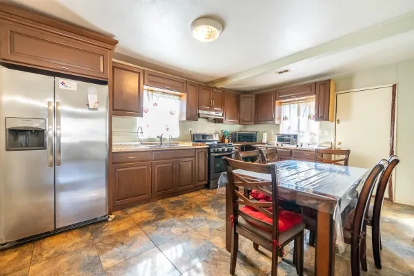 a kitchen with a stove a sink and a refrigerator