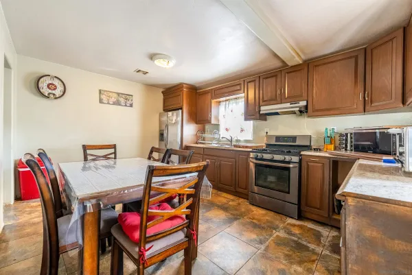 a kitchen with a sink a stove and chairs