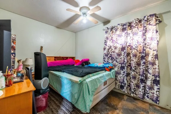a bedroom with bed and a chandelier