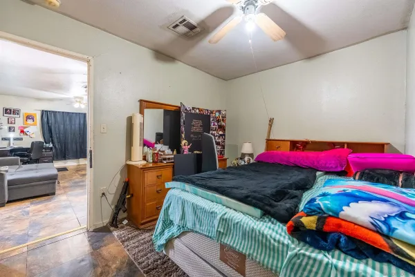 a bedroom with a bed and a couch