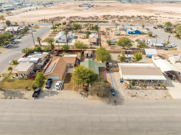 an aerial view of residential houses with outdoor space