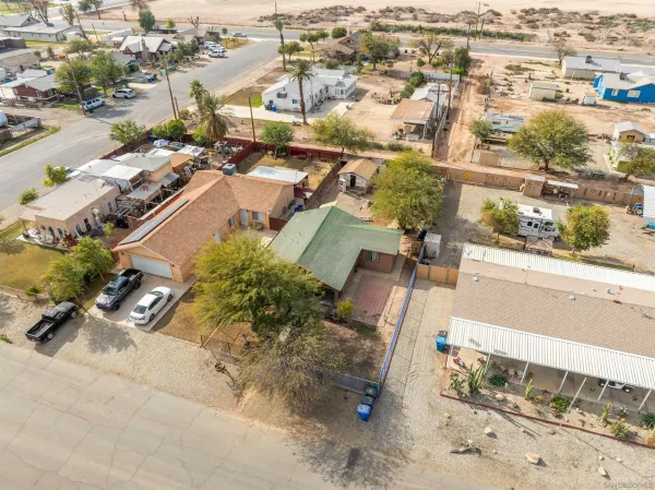 an aerial view of residential houses with outdoor space