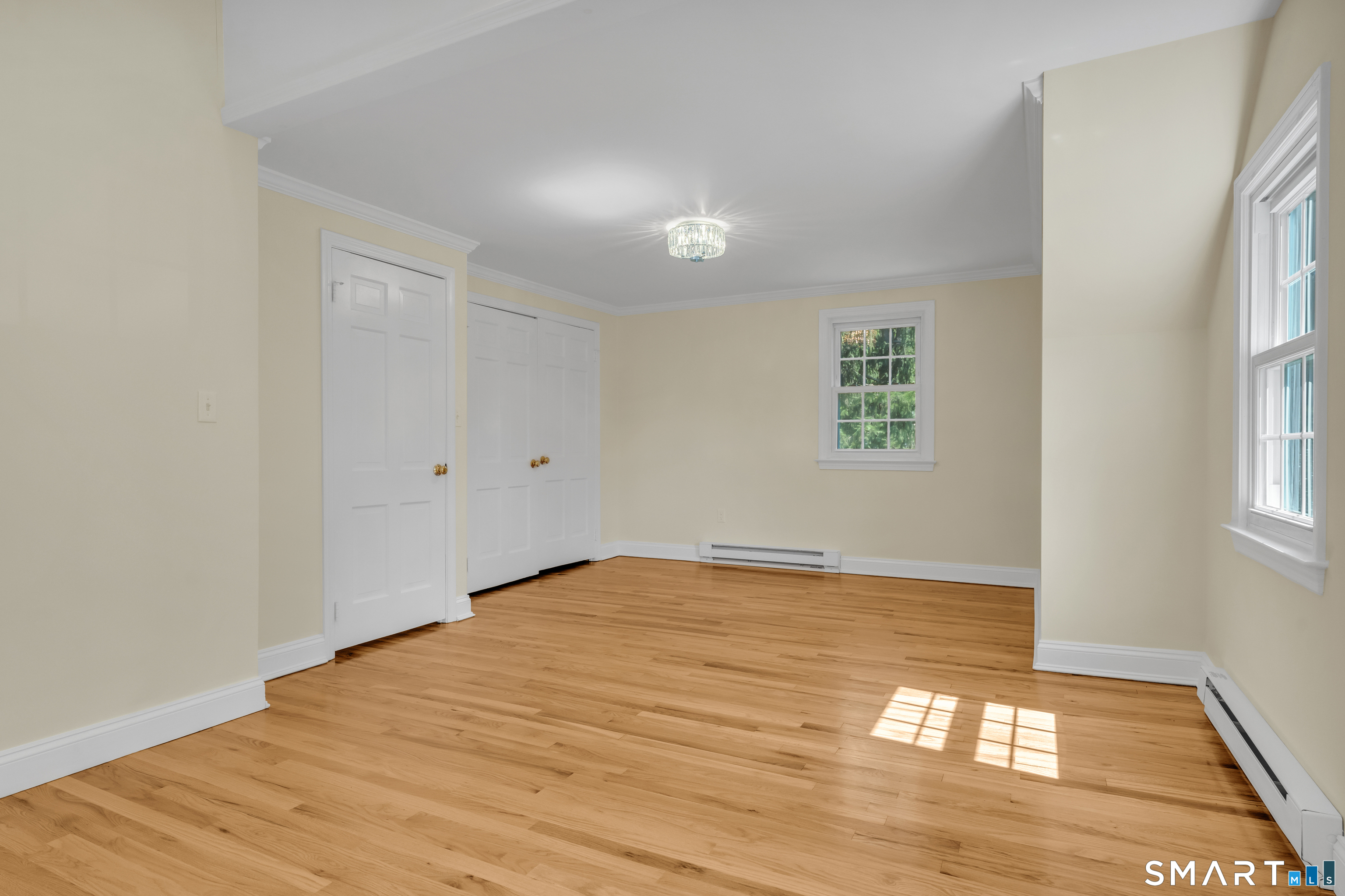 110 Nut Plains Road Guilford, CT 06437 - Photo 27 of 40 Newly refinished hardwood floors gleam in this spacious second floor bedroom with double closets and charming dormer windows.