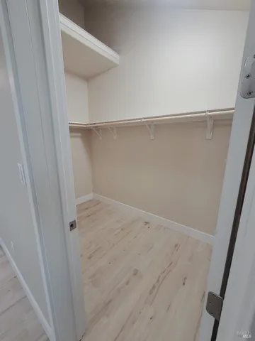 a view of storage and utility room with wooden floor
