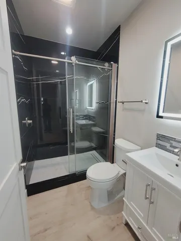 a bathroom with a shower a toilet and a sink