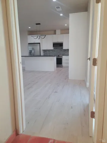 a view of kitchen with wooden floor