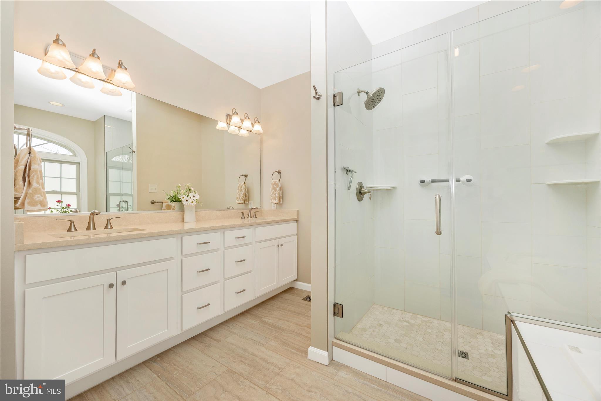 6181 Challedon Circle Mount Airy, MD 21771 - Photo 26 of 63 a bathroom with a shower sink and mirror