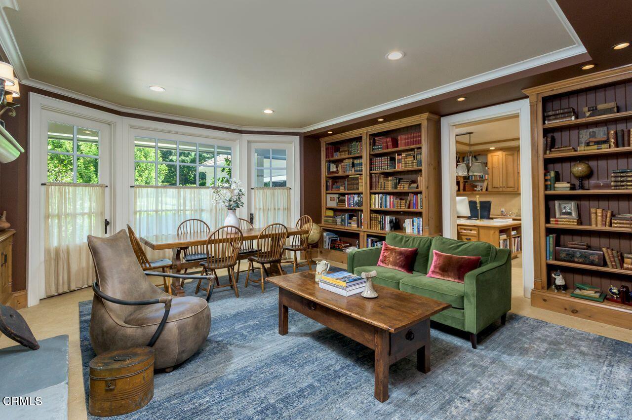 520 Georgian Road La Canada Flintridge, CA 91011 - Photo 24 of 75 a living room with furniture a bookshelf and a large window