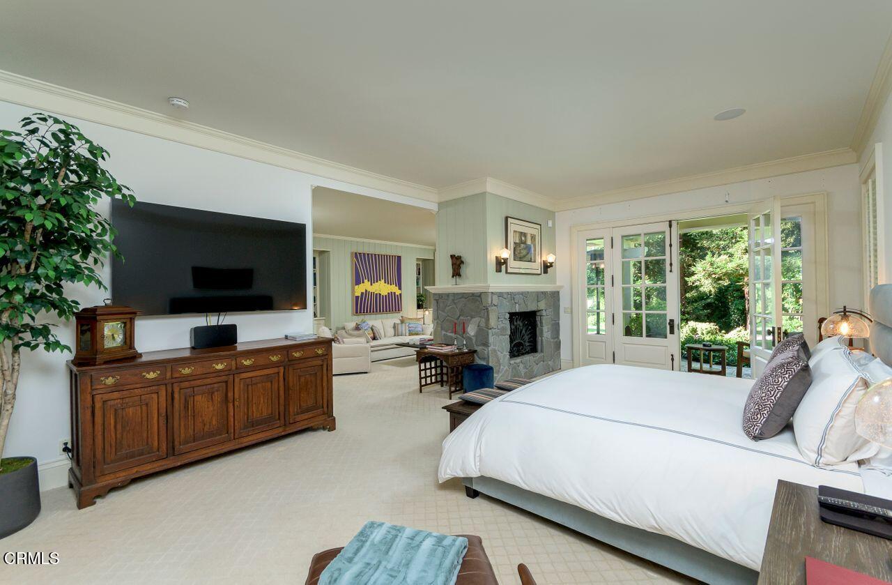 520 Georgian Road La Canada Flintridge, CA 91011 - Photo 29 of 75 a bedroom with a bed a flat screen tv and a couch