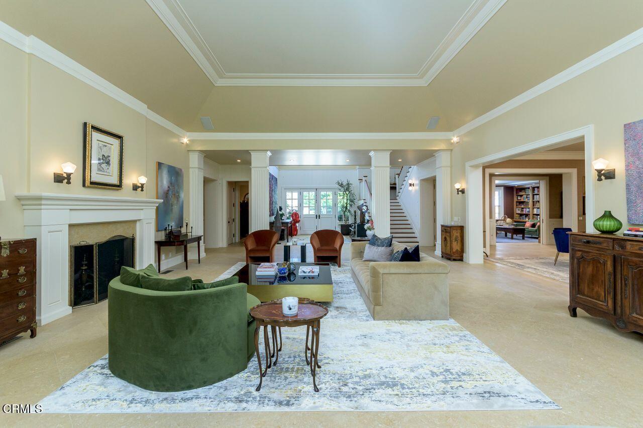 520 Georgian Road La Canada Flintridge, CA 91011 - Photo 7 of 75 a living room with furniture a fireplace and a table