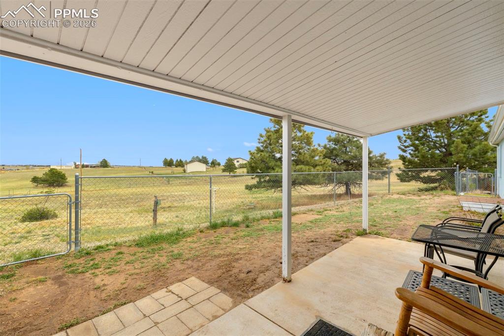 13335 Gymkhana Road Peyton, CO 80831 - Photo 33 of 38 Covered patio featuring a concrete slab and a metal roof structure