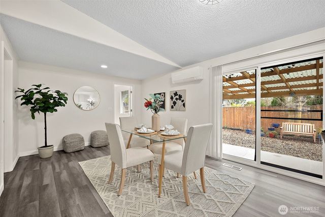 a view of a dining room with furniture and a large window