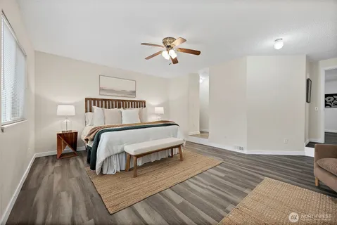 a bedroom with a bed and wooden floor