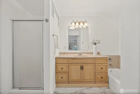 a bathroom with a granite countertop sink a mirror and a