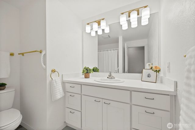 a bathroom with a sink a toilet and a mirror