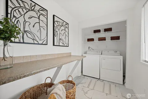 a utility room with a sink a washer and dryer