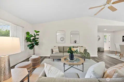 a living room with furniture potted plant and a window