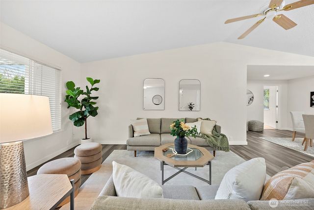 a living room with furniture potted plant and a window