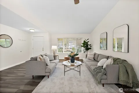 a living room with furniture flowerpot and window