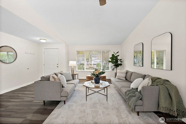 a living room with furniture flowerpot and window