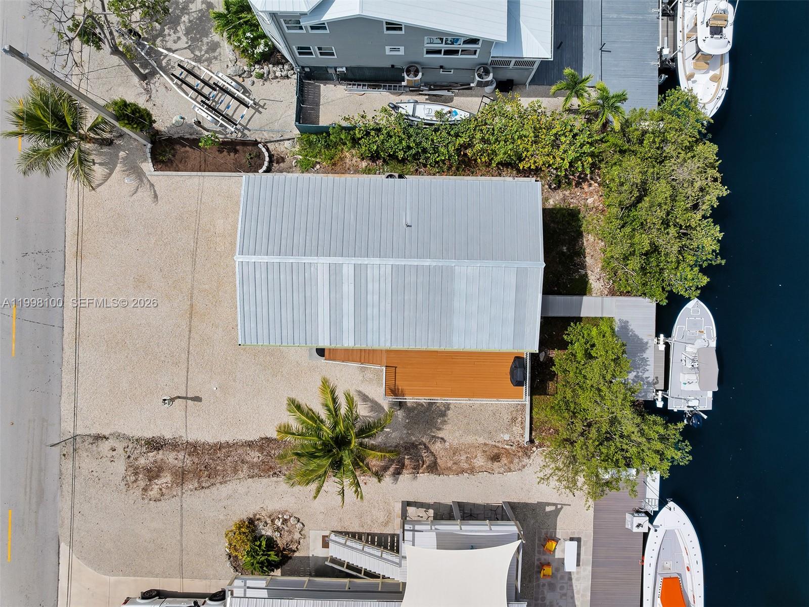 437 Pirates Road Summerland Key, FL 33042 - Photo 12 of 39 an aerial view of a house with a yard and a sitting area
