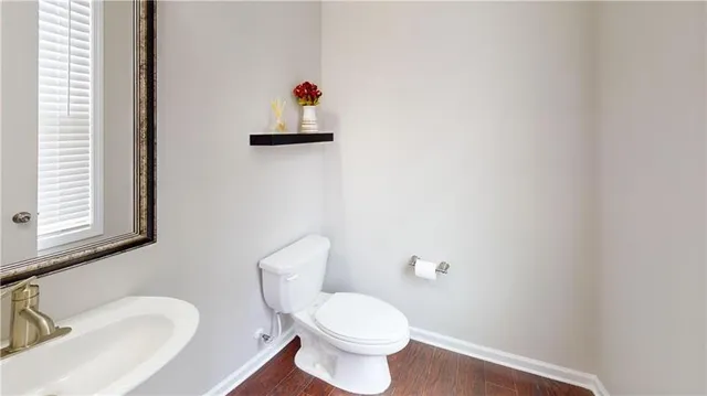 a white toilet sitting next to a bathroom sink